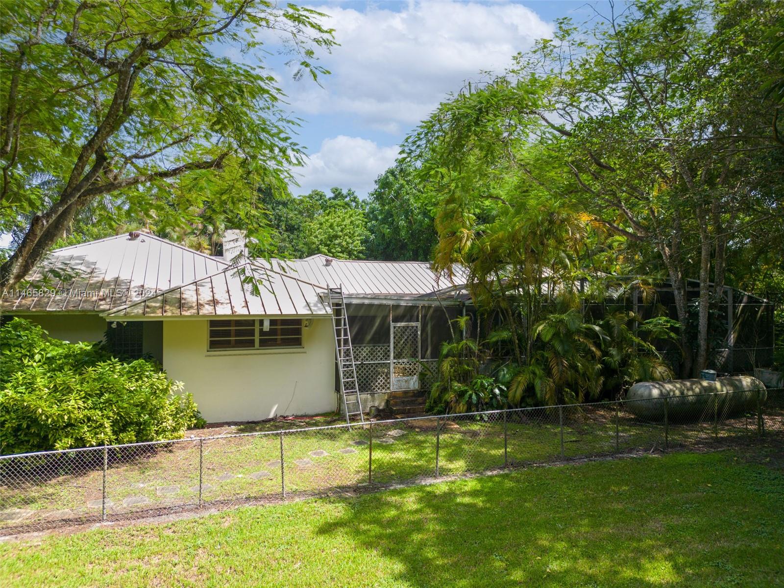 6000 Southwest 118th Avenue Miami, FL 33183 - Photo 34 of 49 a view of a house with a backyard and a patio