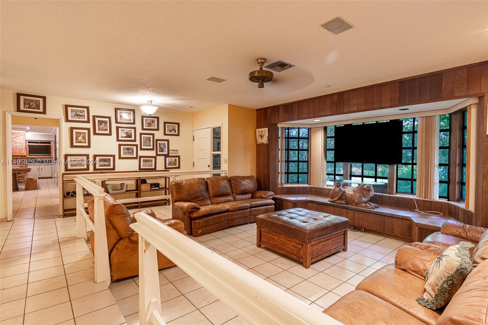 6000 Southwest 118th Avenue Miami, FL 33183 - Photo 9 of 49 a living room with furniture and a flat screen tv