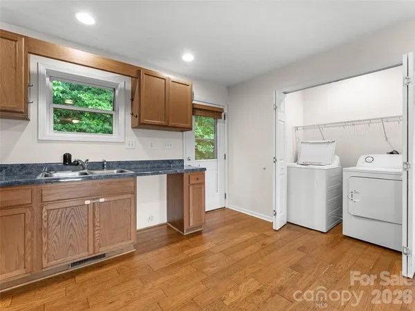 a kitchen with a sink cabinets and window