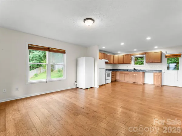 a view of kitchen with wooden floor and electronic appliances