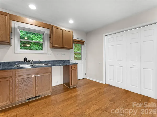 a kitchen with stainless steel appliances granite countertop a sink and a stove top oven