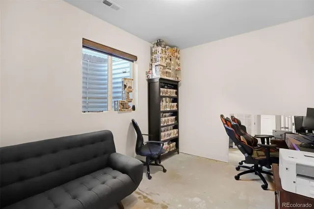 a view of a livingroom with workspace and a window