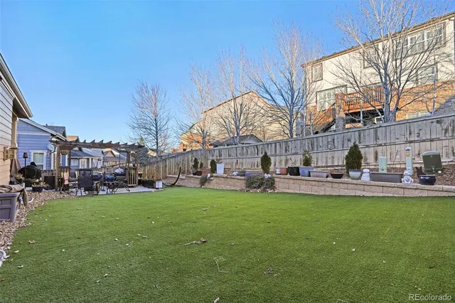 a view of a house with a big yard and sitting area