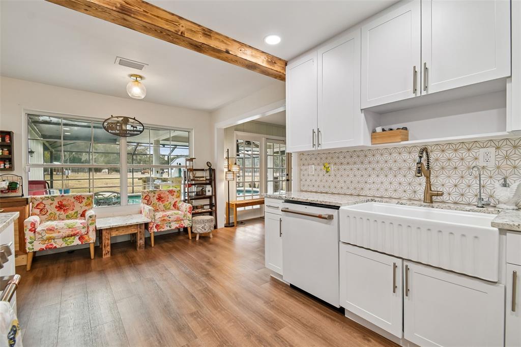 3009 Jim Johnson Road Plant City, FL 33566 - Photo 14 of 84 a kitchen with white cabinets and wooden floor