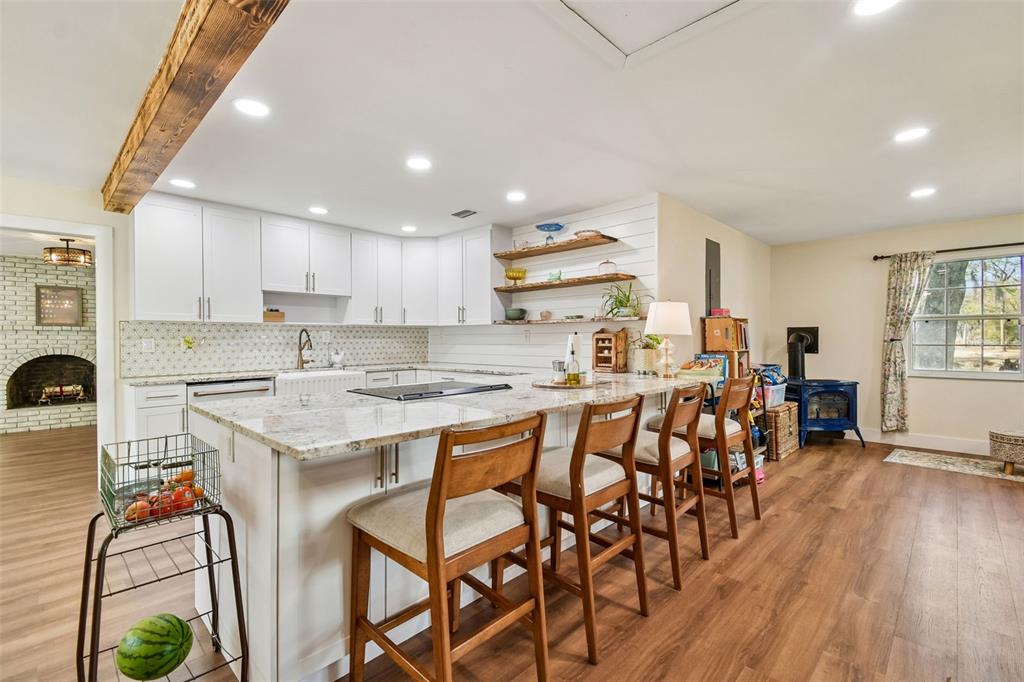 3009 Jim Johnson Road Plant City, FL 33566 - Photo 22 of 84 a kitchen with stainless steel appliances a table and chairs in it