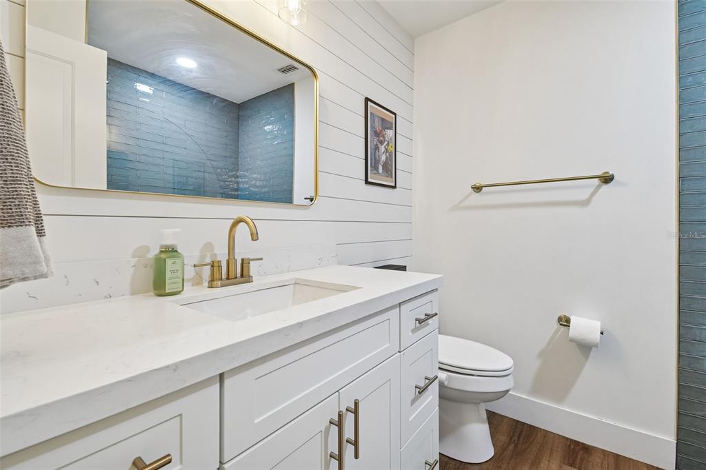 3009 Jim Johnson Road Plant City, FL 33566 - Photo 24 of 84 a bathroom with a granite countertop toilet sink and mirror
