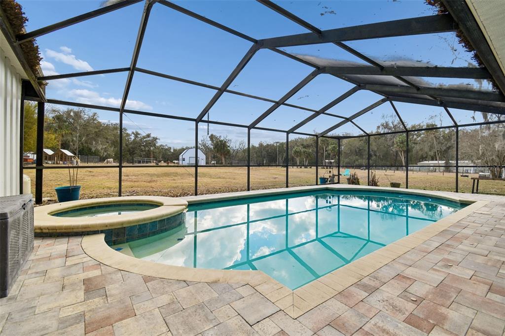 3009 Jim Johnson Road Plant City, FL 33566 - Photo 3 of 84 a view of a swimming pool with a porch