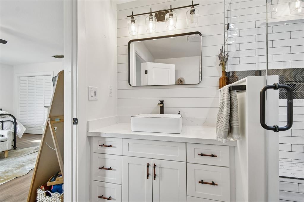 3009 Jim Johnson Road Plant City, FL 33566 - Photo 34 of 84 a bathroom with a sink vanity and mirror