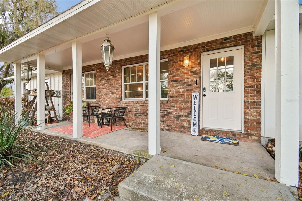 3009 Jim Johnson Road Plant City, FL 33566 - Photo 4 of 84 a view of a porch with a table and chairs