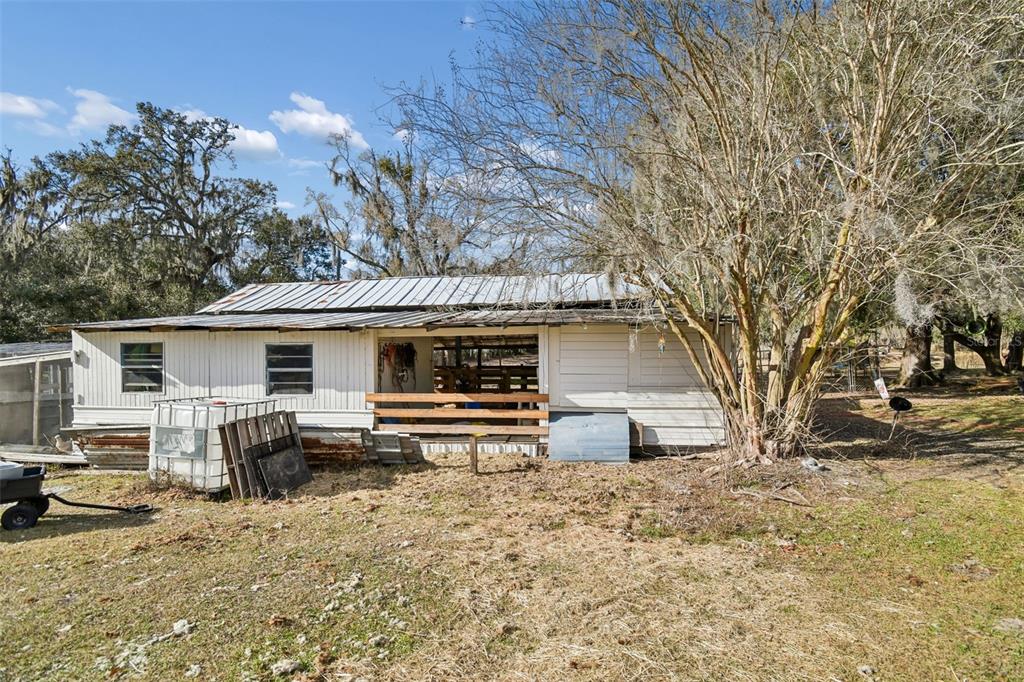 3009 Jim Johnson Road Plant City, FL 33566 - Photo 56 of 84 a front view of house with yard and trees in the background