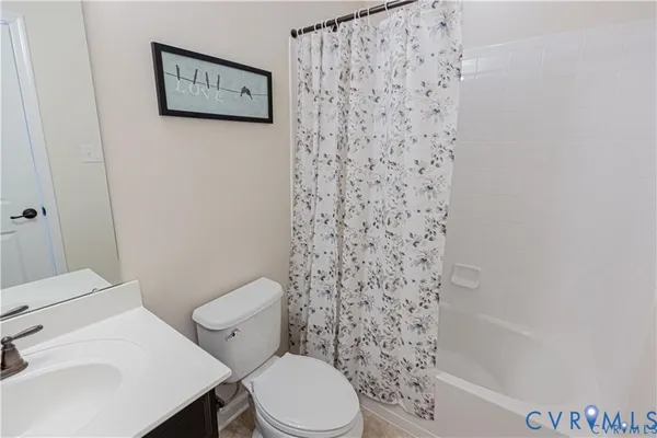 a white toilet sitting next to a shower curtain