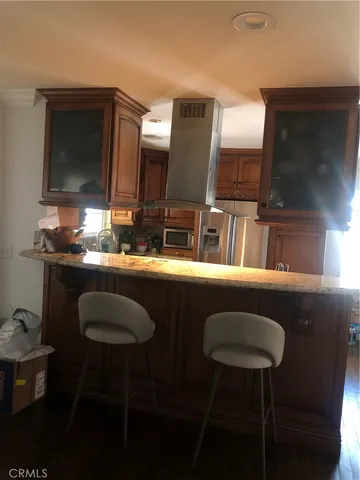 a kitchen with stainless steel appliances granite countertop sink stove and refrigerator