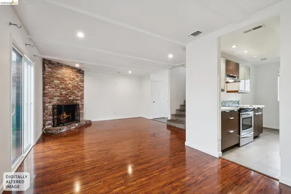 a view of a kitchen and a livingroom with a fireplace