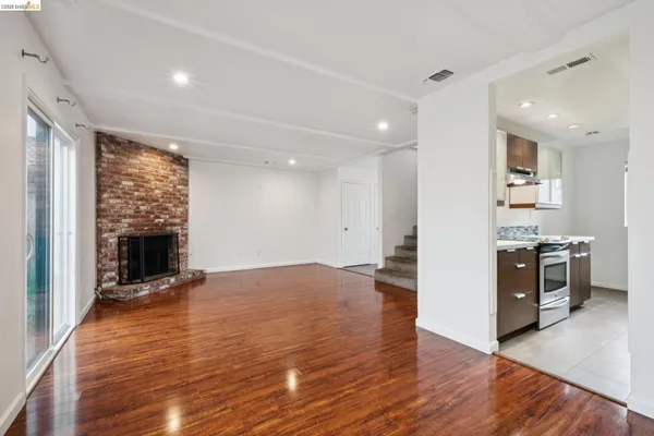 a view of a kitchen with a stove cabinets and wooden floor