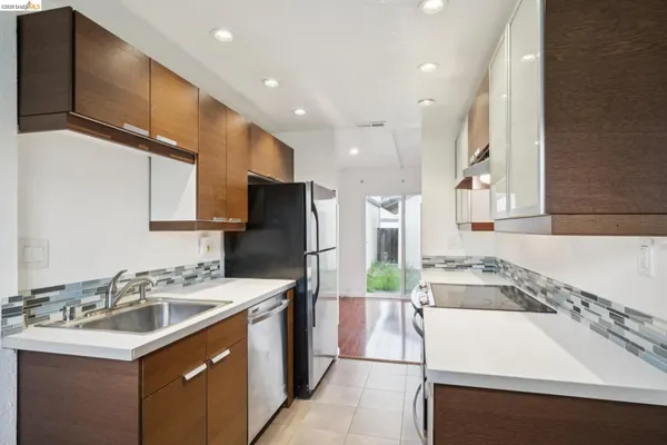 a kitchen with a sink a stove a refrigerator and a sink