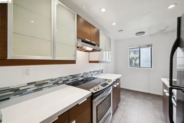 a kitchen that has a sink a stove and a microwave