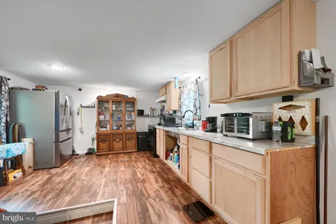 a kitchen with stainless steel appliances a refrigerator sink and cabinets
