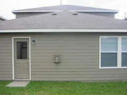 a kitchen with stainless steel appliances a sink a stove a microwave a refrigerator a cabinets and wooden floor