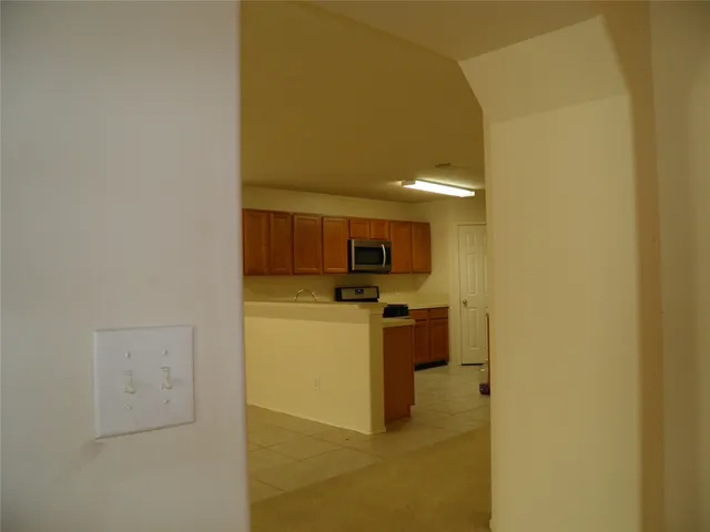 a view of a hallway with a kitchen