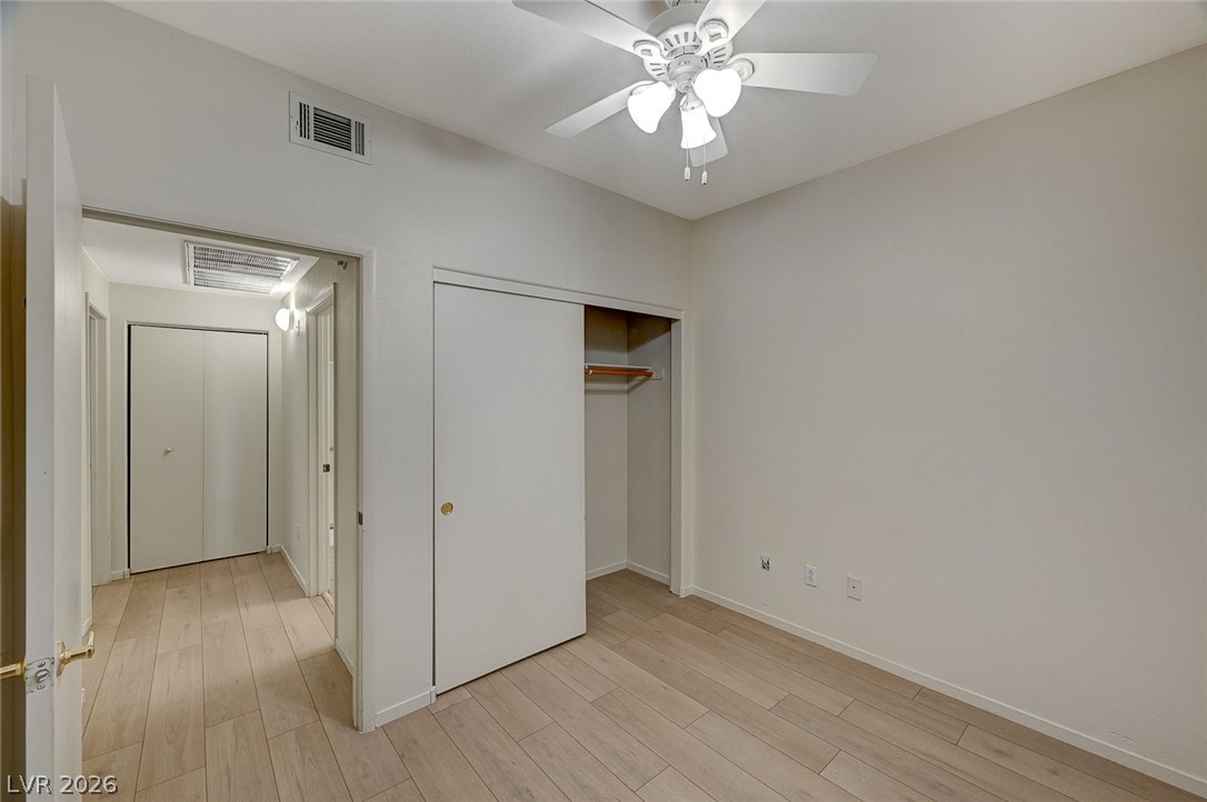 9050 West Warm Springs Road, Unit 1147 Las Vegas, NV 89148 - Photo 33 of 36 An inviting bedroom features durable wood flooring and a convenient sliding closet.