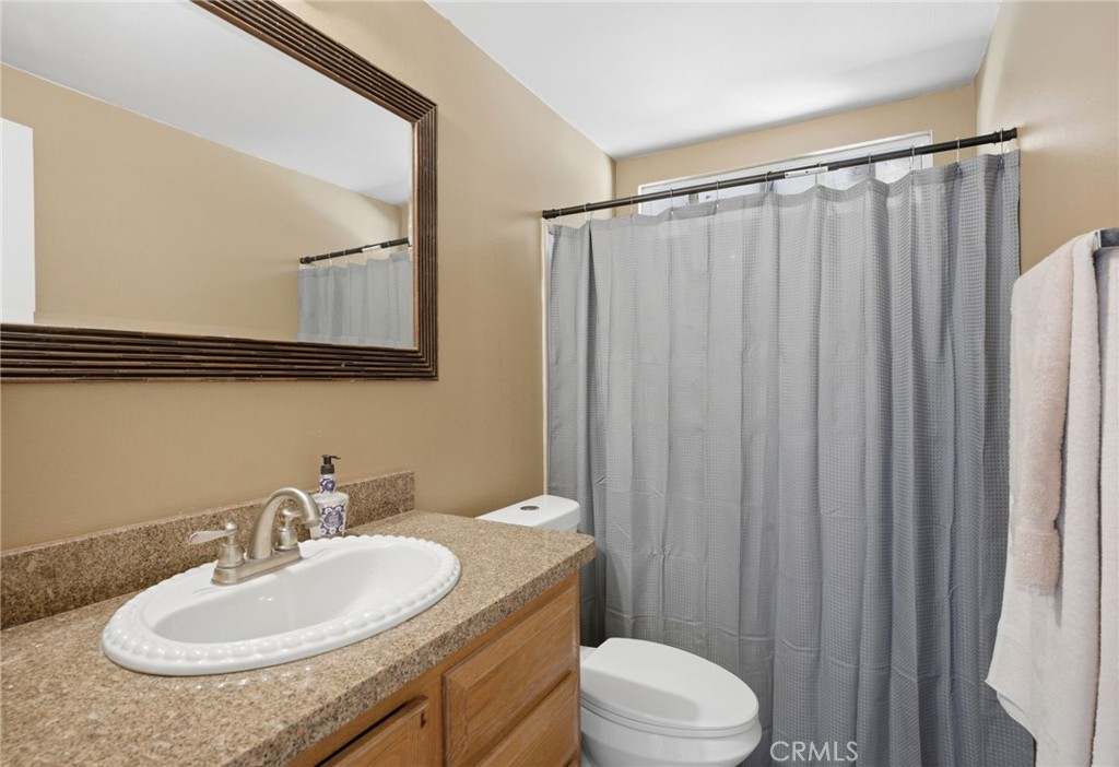 40100 Owl Valley Road Temecula, CA 92592 - Photo 20 of 44 a bathroom with a sink vanity mirror and toilet