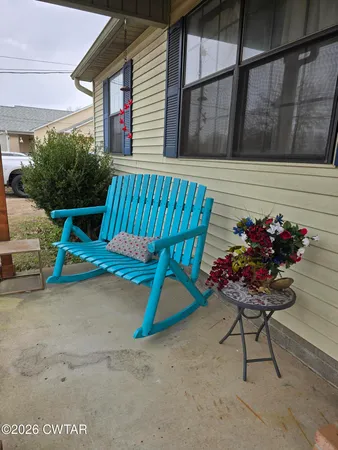 a backyard of a house with table and chairs