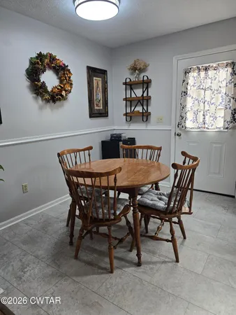 a view of a dining room with furniture and window