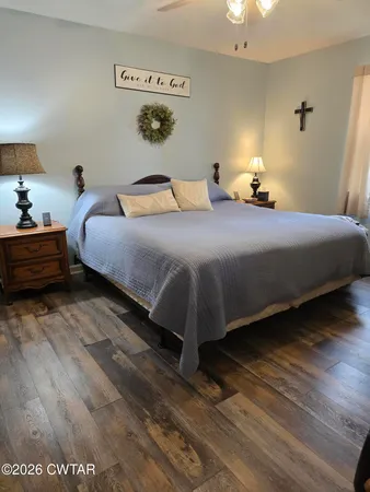 a bedroom with a bed and a night stand
