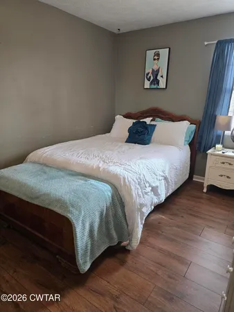 a bedroom with a bed and a night stand