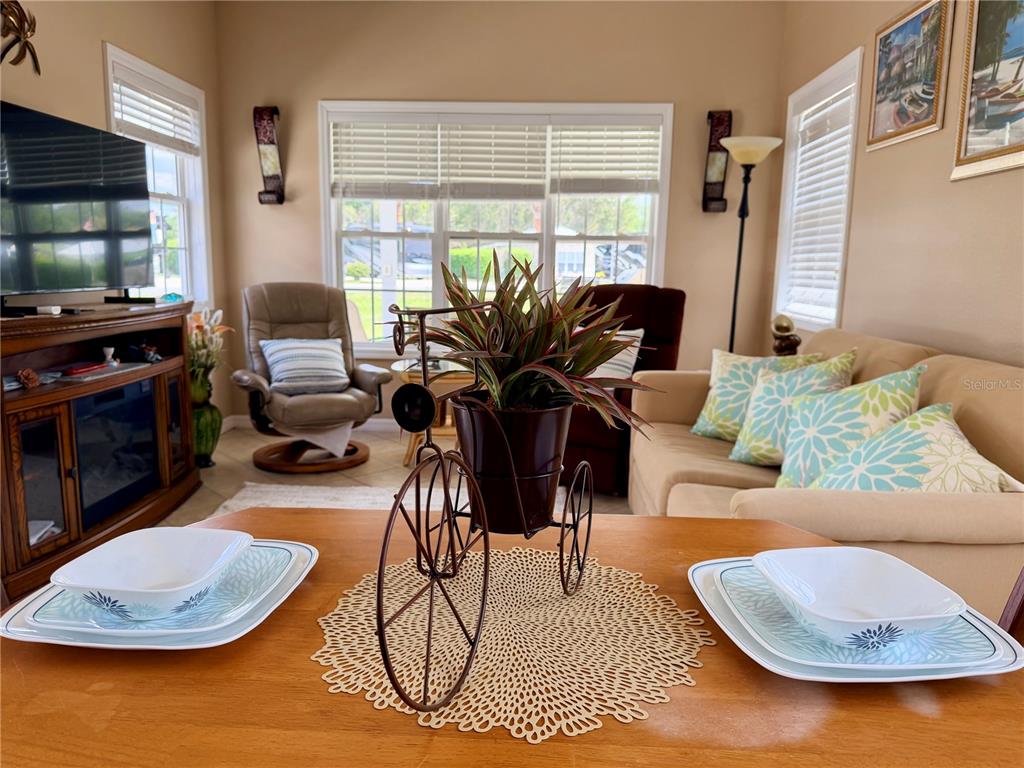 9501 Southeast 47th Way Webster, FL 33597 - Photo 13 of 35 a living room with furniture and a flat screen tv