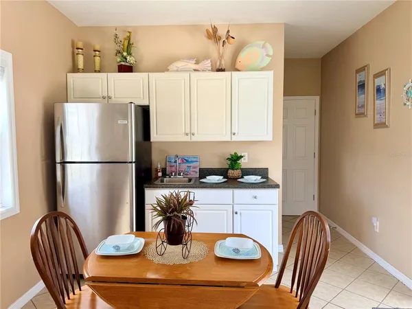 a kitchen with a refrigerator and a table