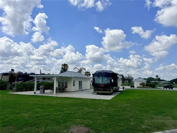 a car parked in front of a house with a big yard