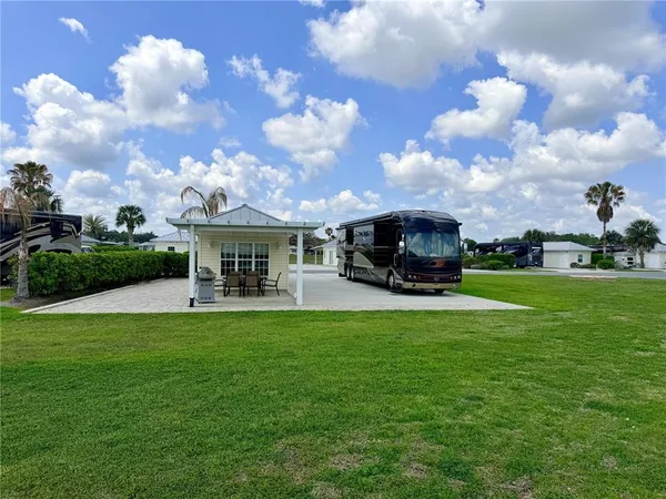 a view of a fountain in front of the house with a big yard