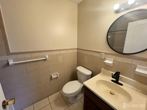 a bathroom with a sink mirror and toilet