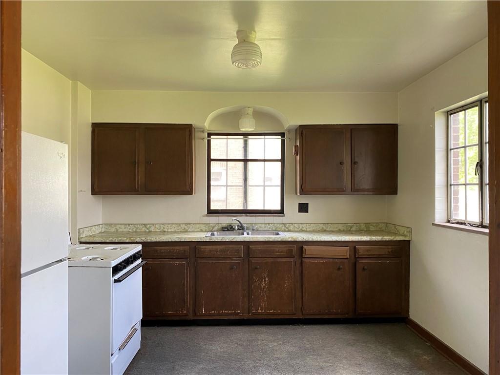 916 Russellton Road Cheswick, PA 15024 - Photo 2 of 10 a kitchen with a sink stove and cabinets