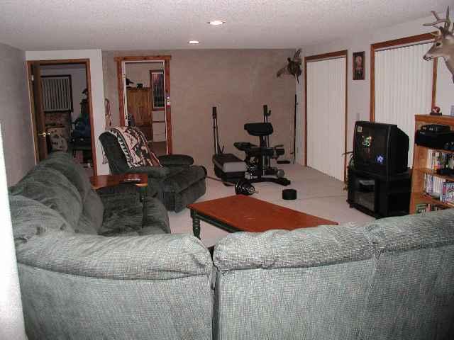 796 County Road, Unit 259 Rifle, CO 81650 - Photo 3 of 8 a living room with furniture and a chandelier