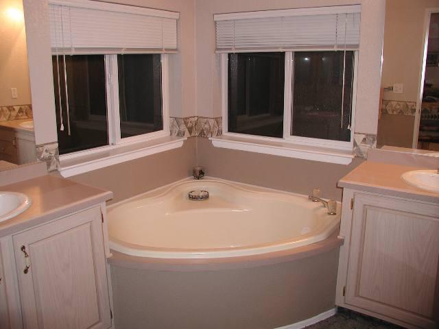 796 County Road, Unit 259 Rifle, CO 81650 - Photo 5 of 8 a white bath tub sitting next to a sink