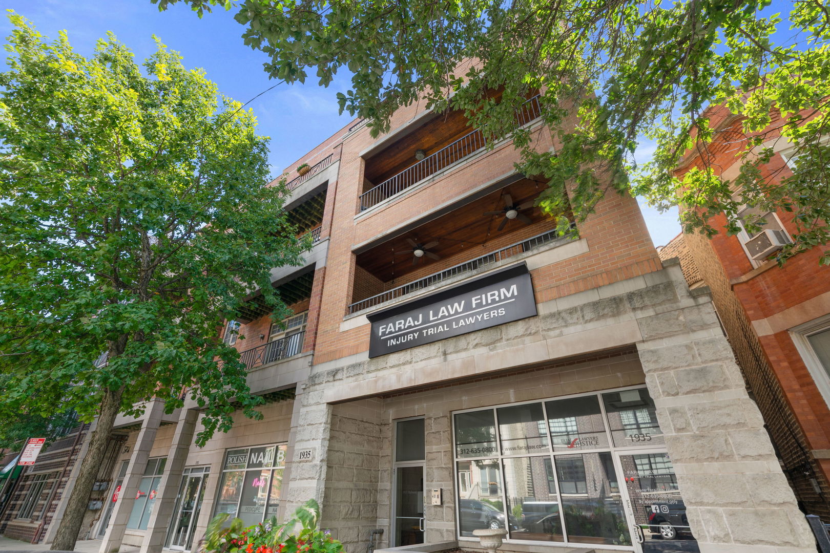 a front view of a house with a tree