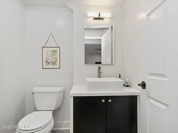 a bathroom with a toilet sink and mirror