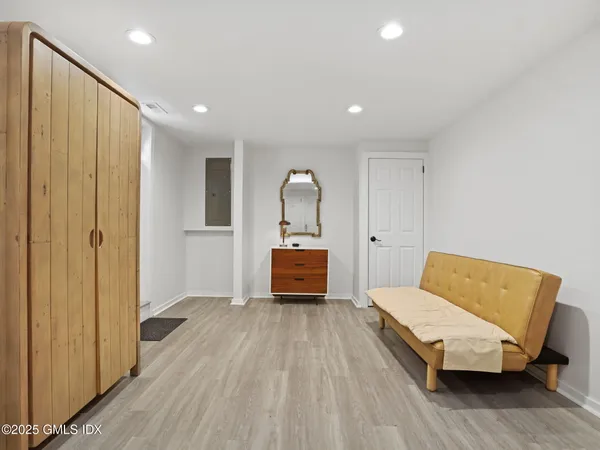 a living room with a bed furniture and a wooden floor