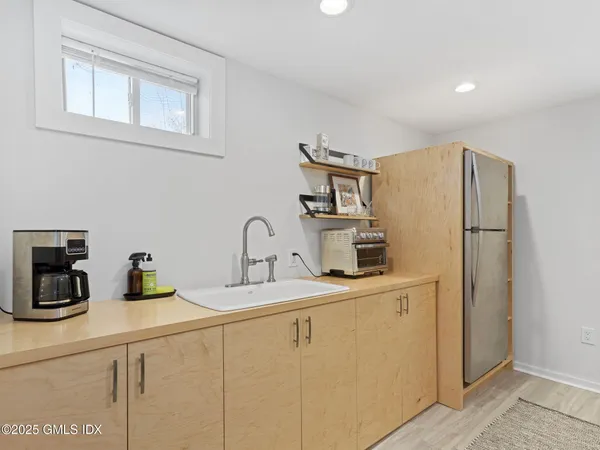 a kitchen with stainless steel appliances a refrigerator sink and cabinets