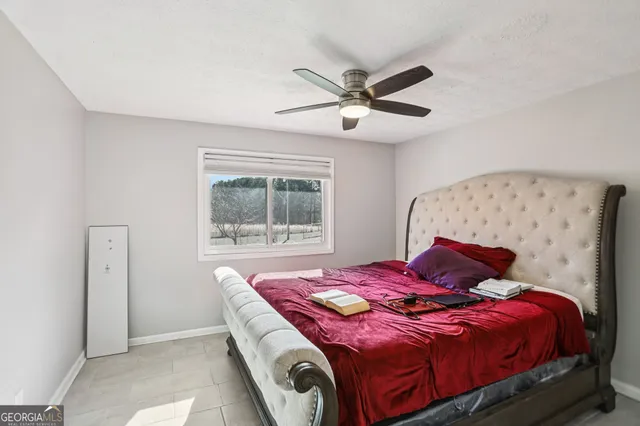 a bedroom with a large bed and a window