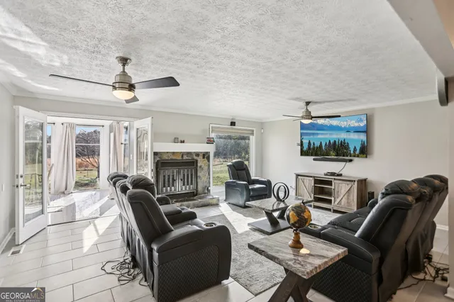 a living room with furniture a fireplace and a flat screen tv