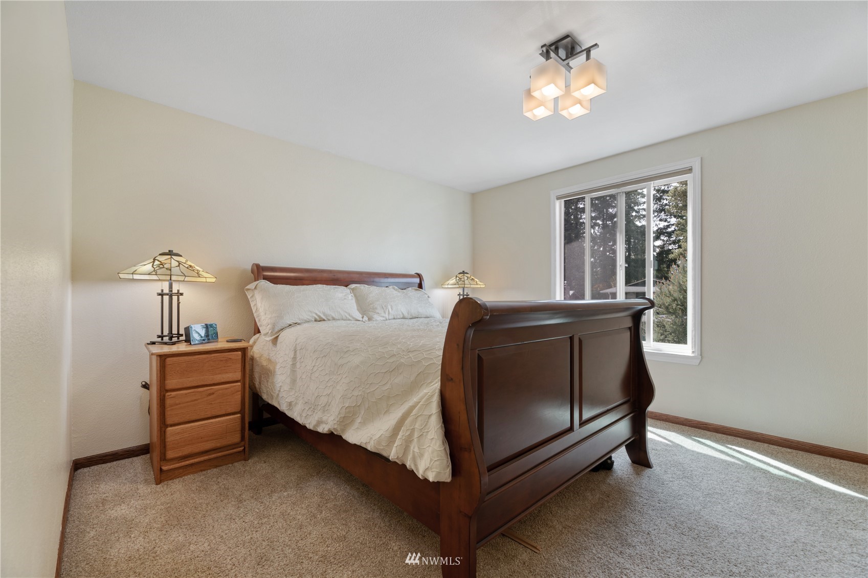 17515 24th Avenue Southeast Bothell, WA 98012 - Photo 15 of 39 a bed sitting in a room next to a lamp