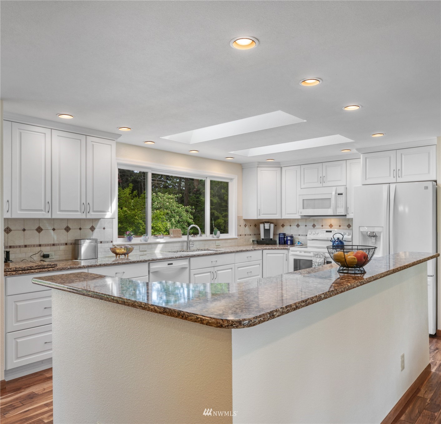 17515 24th Avenue Southeast Bothell, WA 98012 - Photo 7 of 39 a kitchen with stainless steel appliances granite countertop a sink a stove and a refrigerator