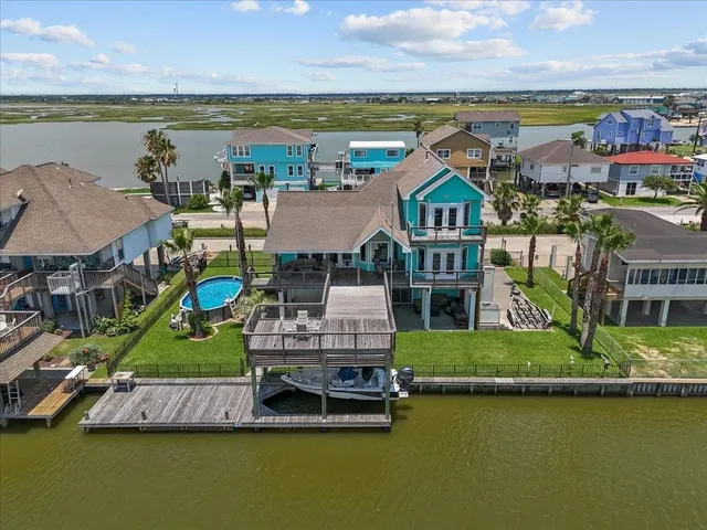 an aerial view of a house with a garden and lake view