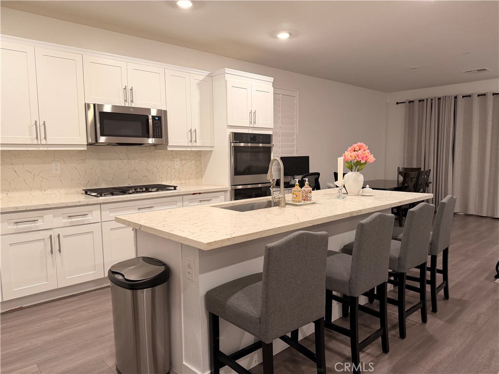 562 Hudson Way Rialto, CA 92377 - Photo 4 of 5 a kitchen with a dining table and chairs