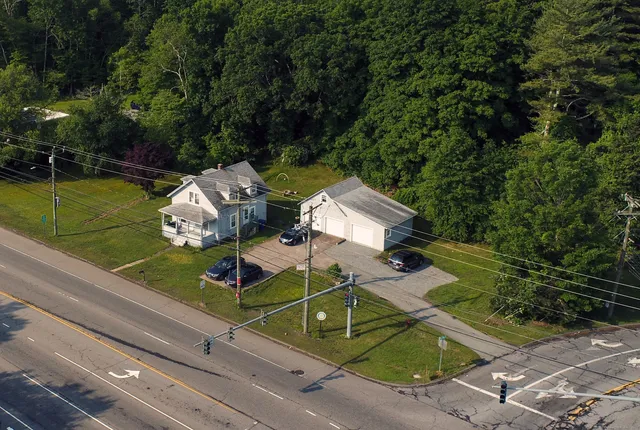 an aerial view of a house with a yard and potted plants