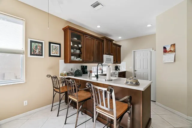 a dining room with furniture a chandelier and window