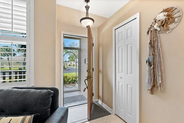 a living room with furniture a two mirror and a window